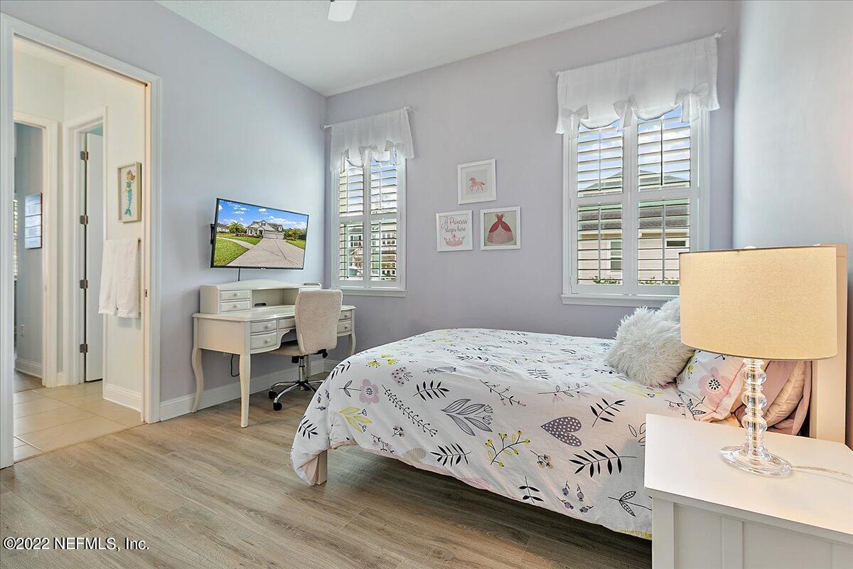 27 Red Twig Way St. Augustine, FL 32092 - Photo 22 of 47 a bedroom with a bed and a table in it with window