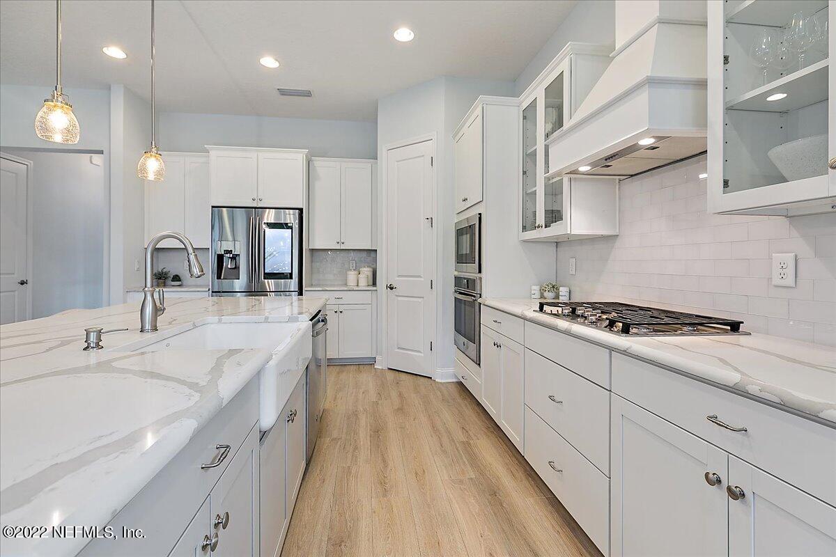 27 Red Twig Way St. Augustine, FL 32092 - Photo 9 of 47 a large white kitchen with stainless steel appliances and a sink