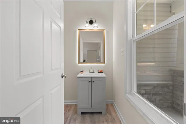 a bathroom with a sink a toilet and mirror