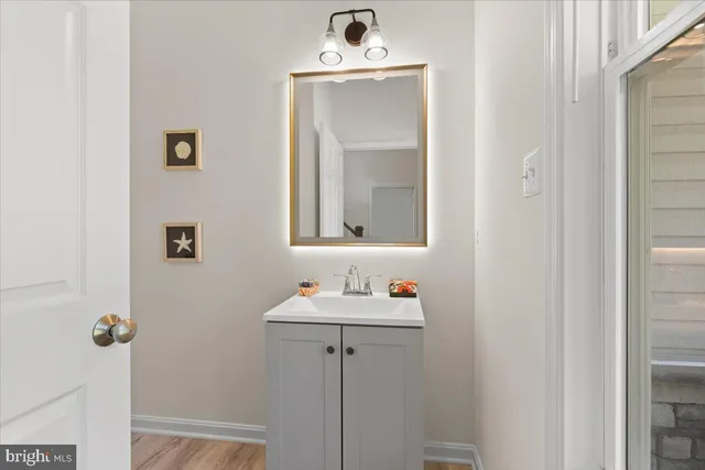 a bathroom with a sink mirror and vanity