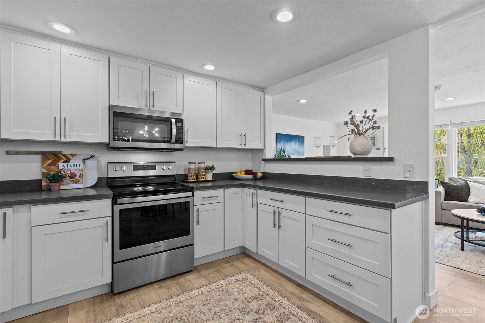 2018 Northeast 97th Street Seattle, WA 98115 - Photo 14 of 39 a kitchen with granite countertop white cabinets appliances and a sink