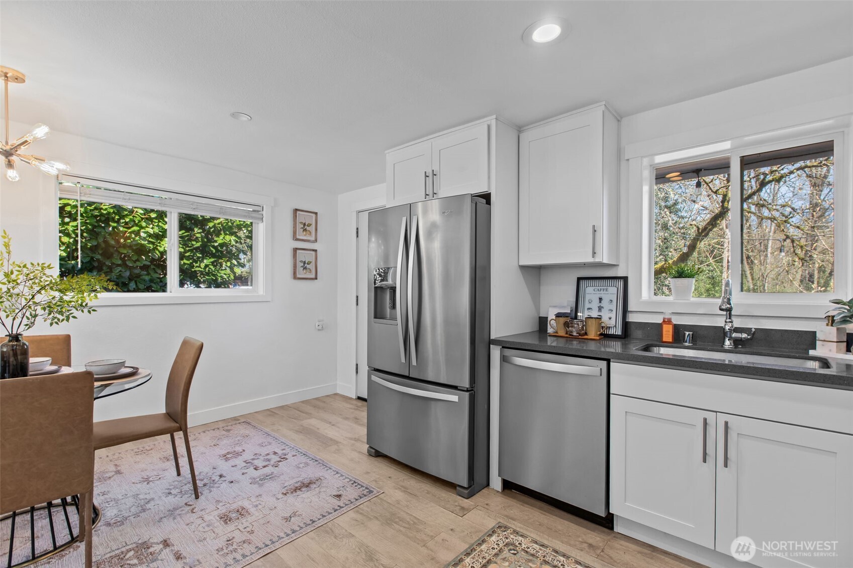 2018 Northeast 97th Street Seattle, WA 98115 - Photo 16 of 39 a kitchen with stainless steel appliances granite countertop a refrigerator a sink a stove a dining table and chairs