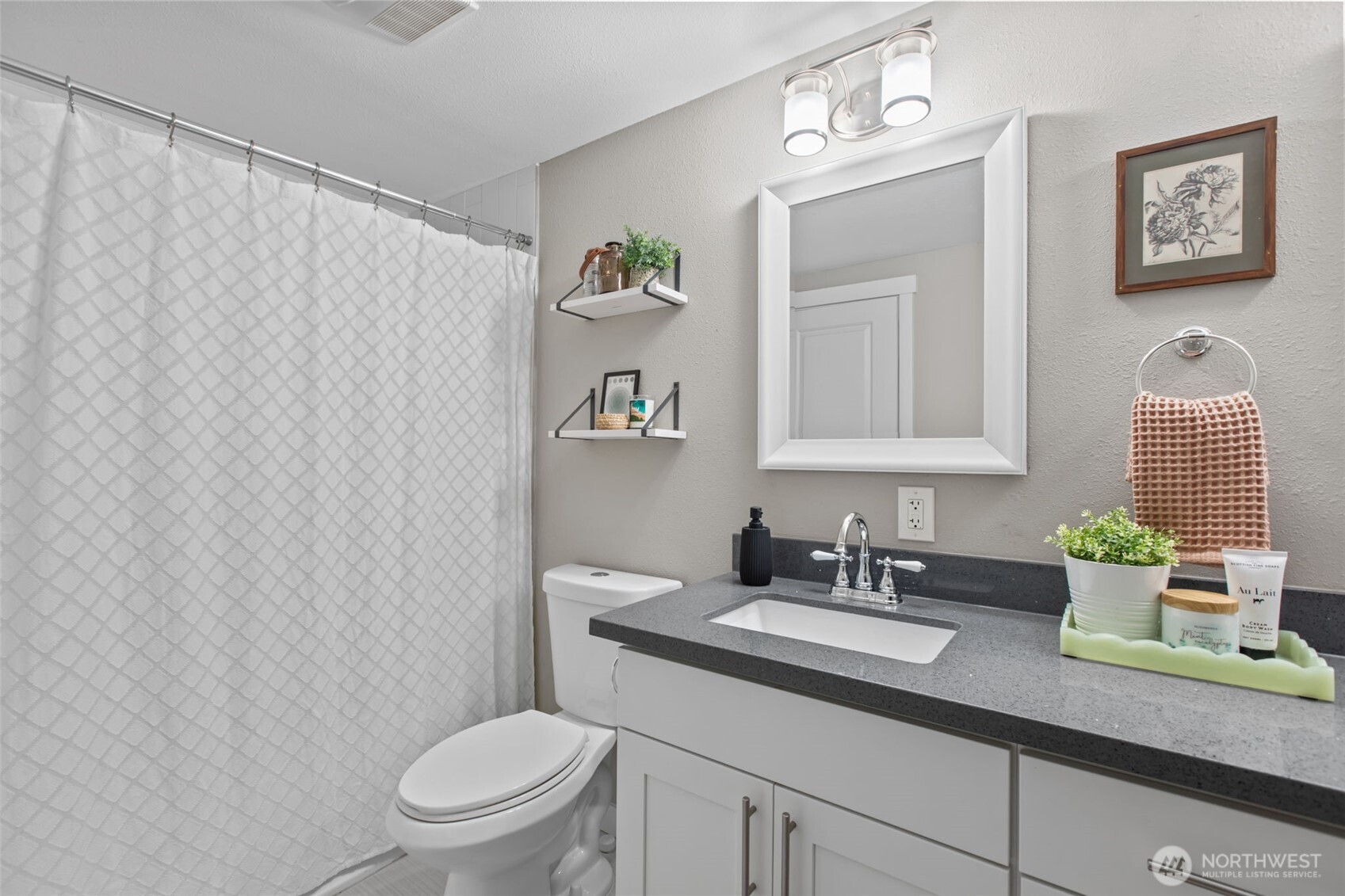 2018 Northeast 97th Street Seattle, WA 98115 - Photo 23 of 39 a bathroom with a granite countertop sink a toilet and a mirror