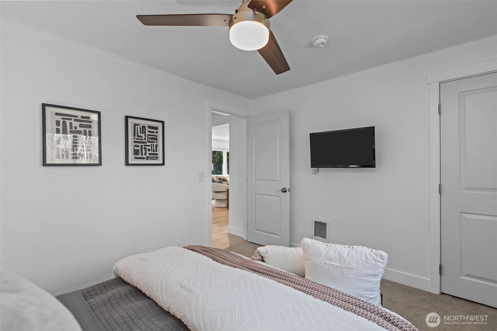 2018 Northeast 97th Street Seattle, WA 98115 - Photo 28 of 39 a bedroom with a bed and a flat screen tv