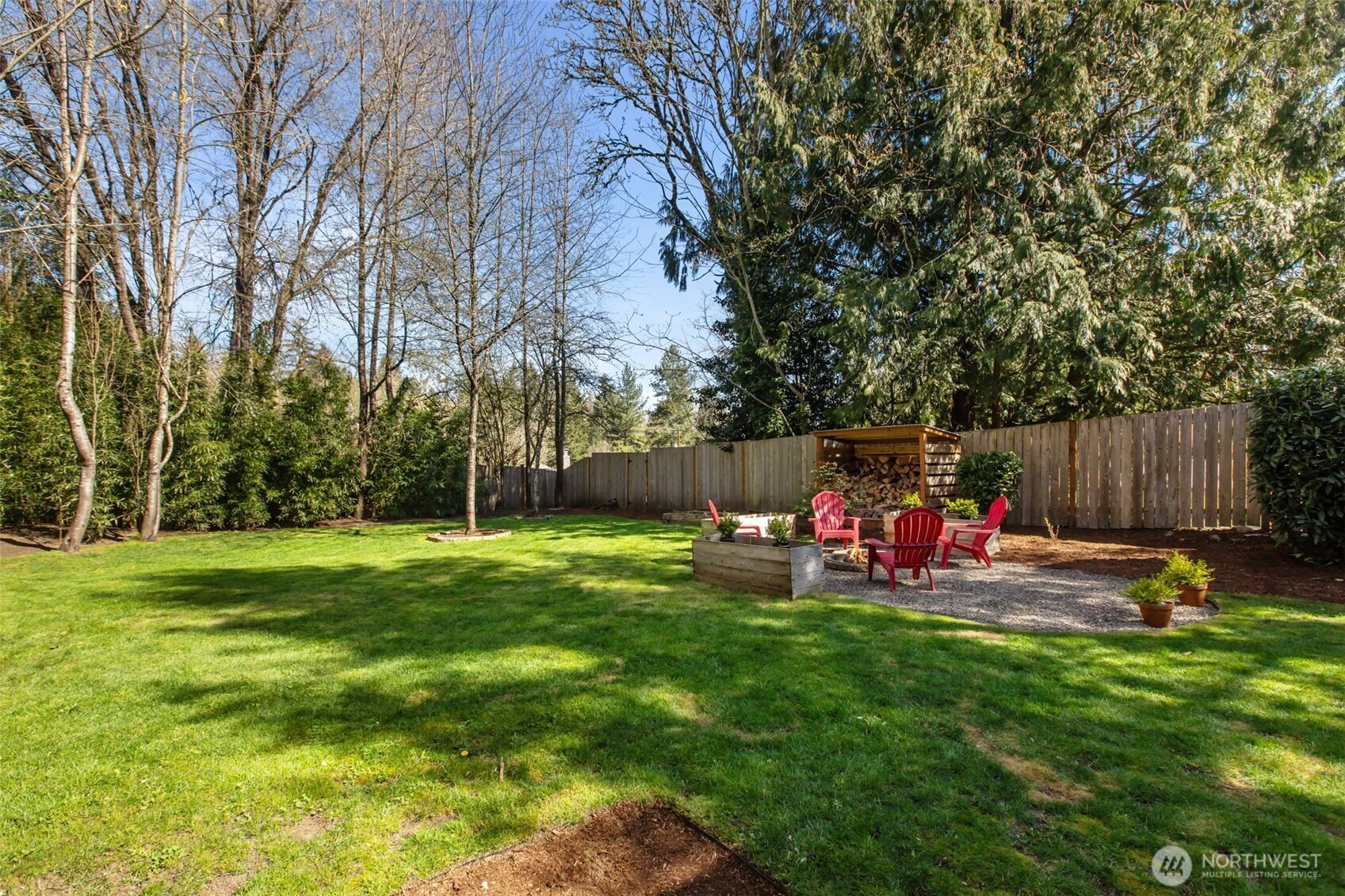 2018 Northeast 97th Street Seattle, WA 98115 - Photo 34 of 39 a view of backyard with wooden fence and a bench