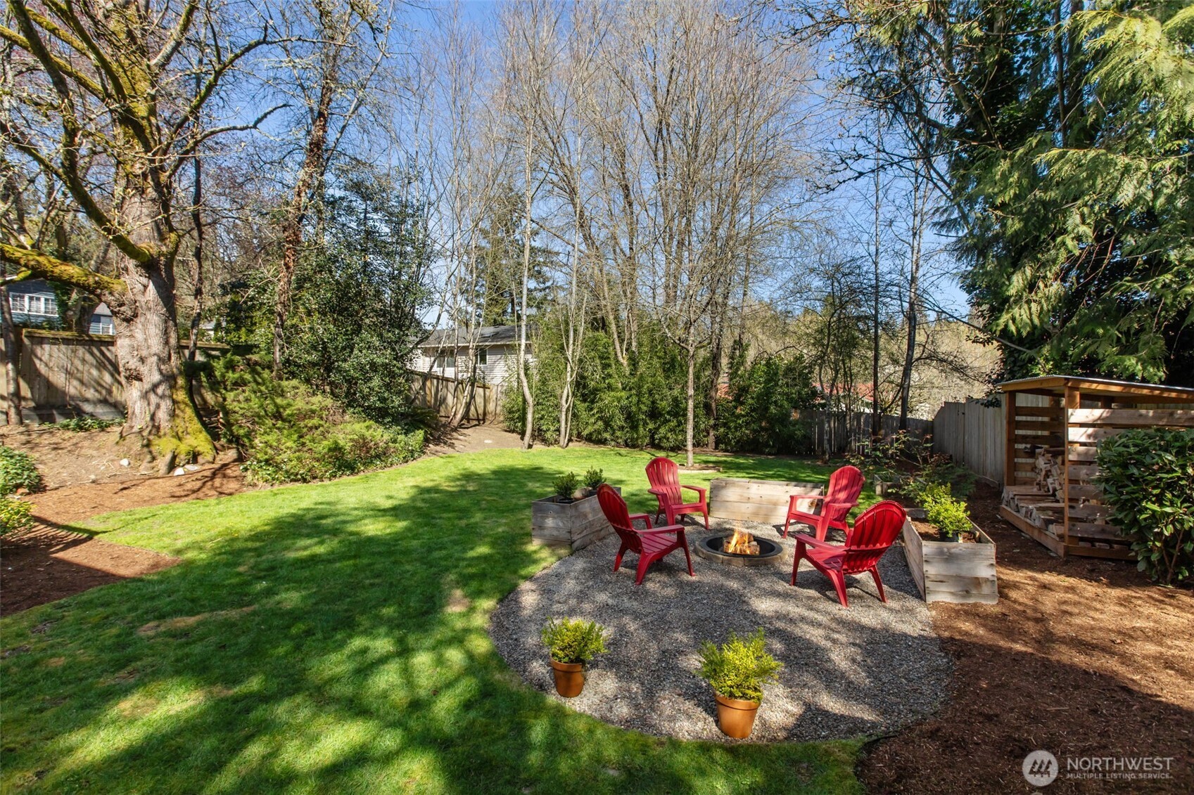2018 Northeast 97th Street Seattle, WA 98115 - Photo 38 of 39 a view of backyard with table and chairs and a fire pit