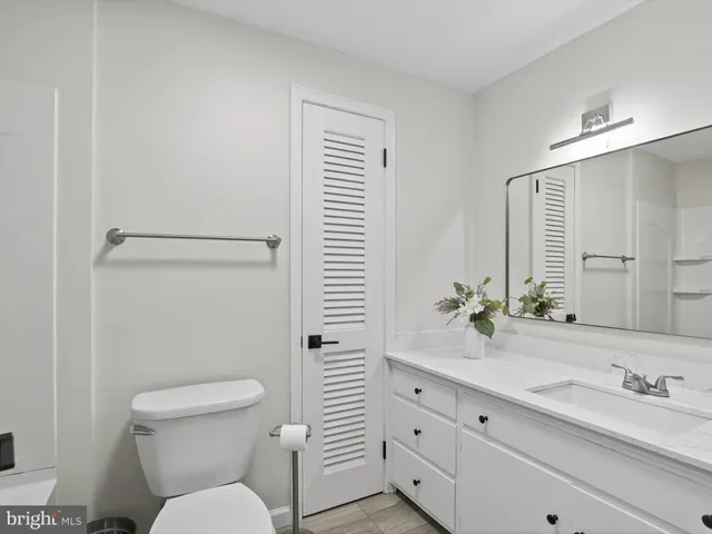 a bathroom with a sink toilet and a mirror