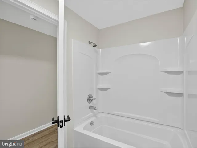 a bedroom with a bed and a refrigerator