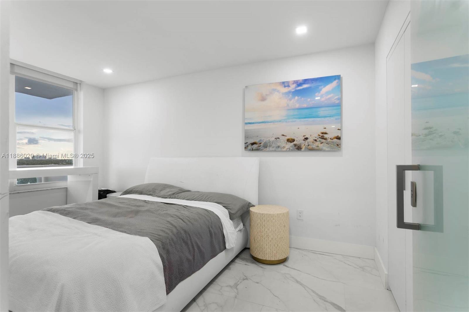 5001 Collins Avenue, Unit 8C Miami Beach, FL 33140 - Photo 11 of 27 a bedroom with a bed and painting on the wall