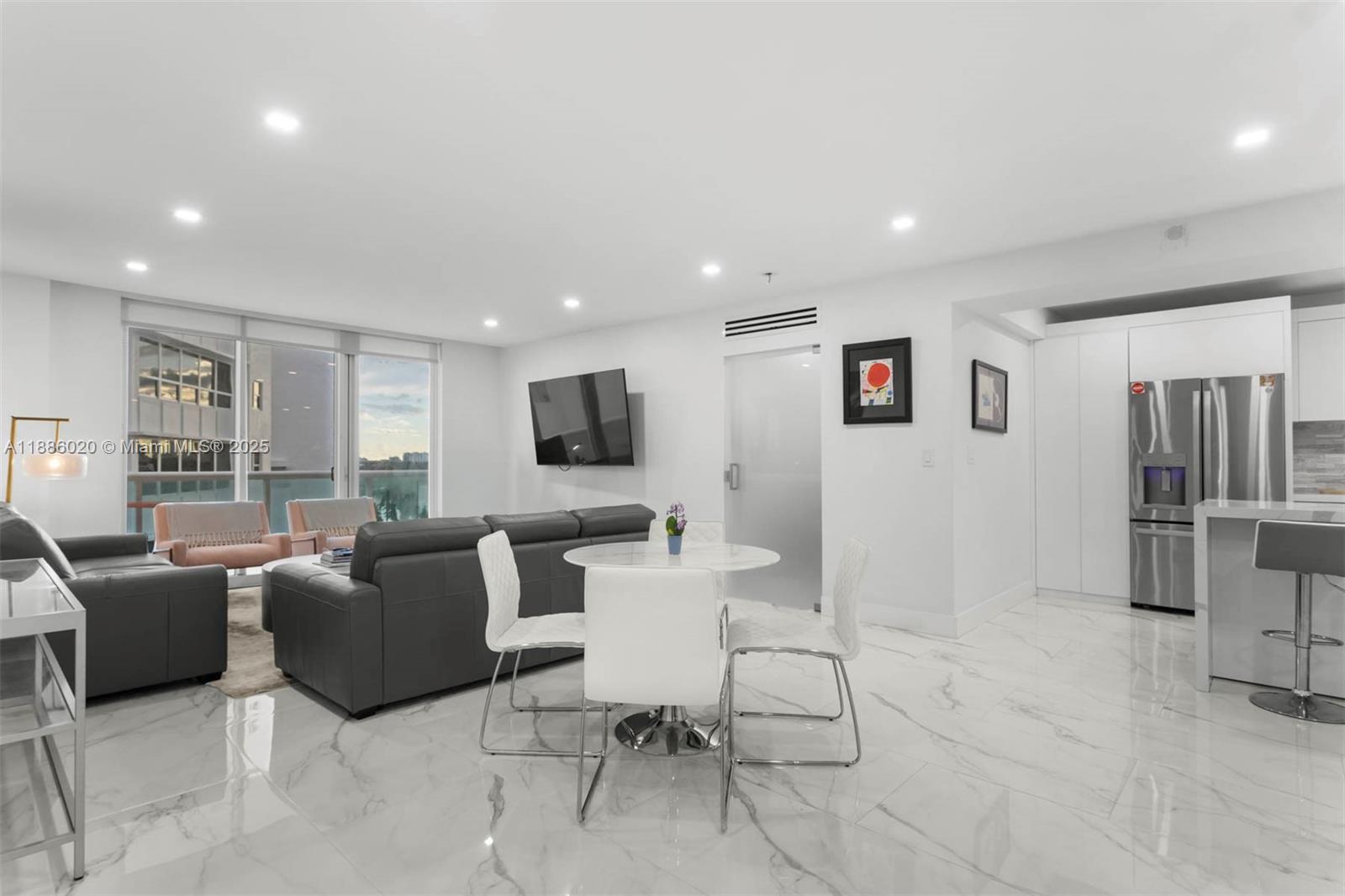 5001 Collins Avenue, Unit 8C Miami Beach, FL 33140 - Photo 13 of 27 a living room with furniture and a flat screen tv