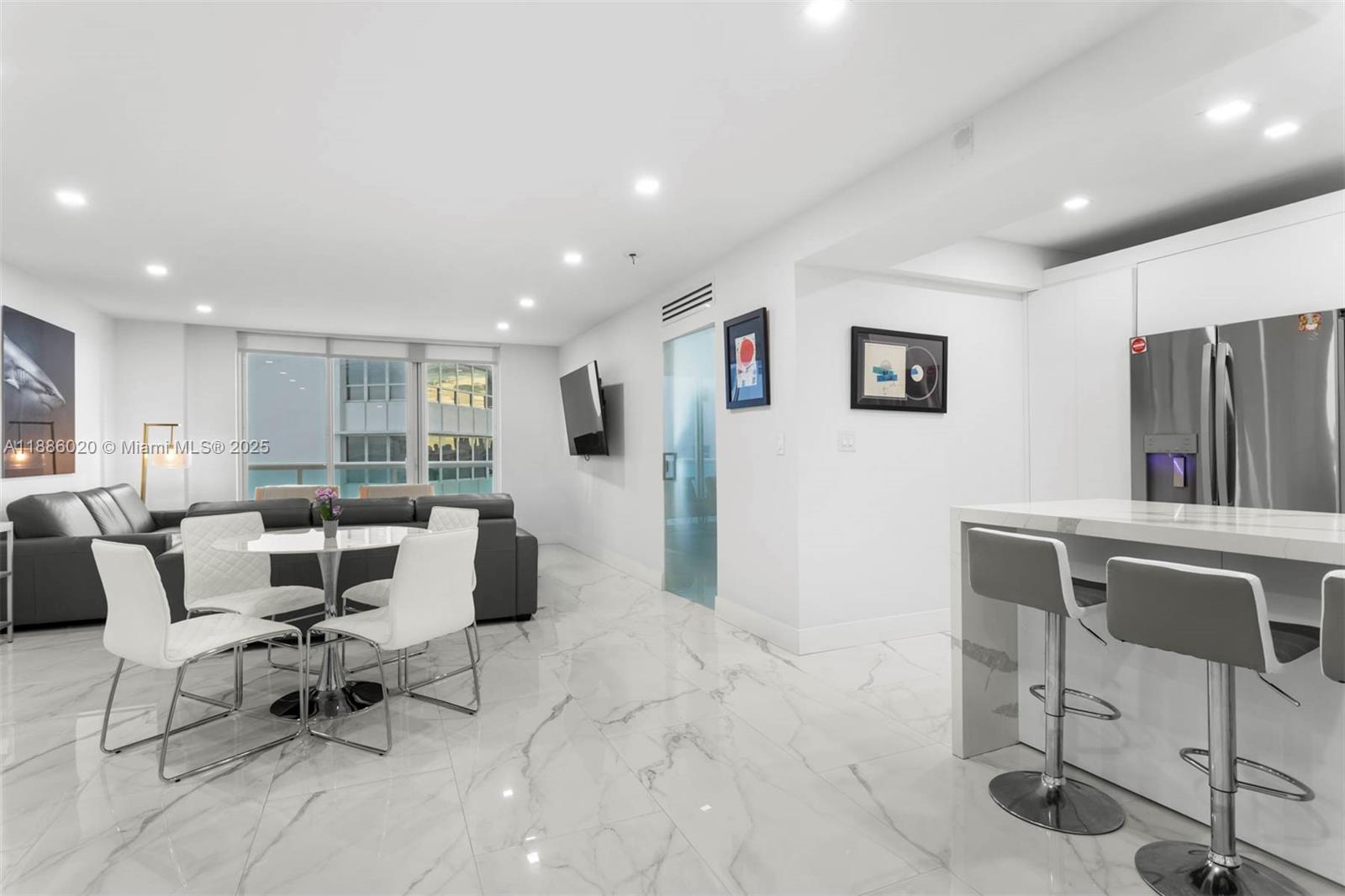 5001 Collins Avenue, Unit 8C Miami Beach, FL 33140 - Photo 16 of 27 a living room with furniture and a flat screen tv