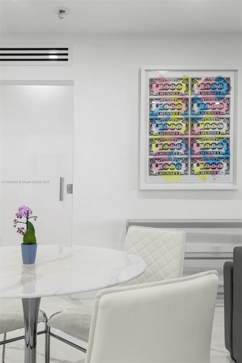 5001 Collins Avenue, Unit 8C Miami Beach, FL 33140 - Photo 26 of 27 a living room with a couch and a potted plant