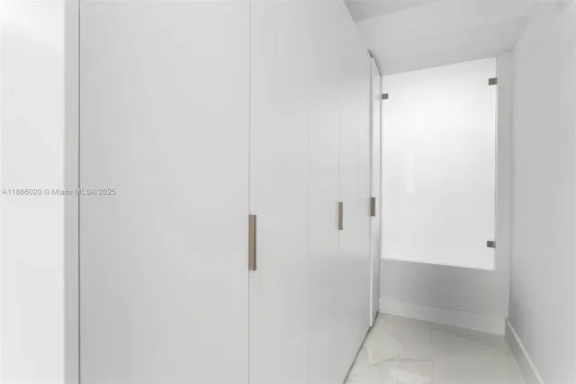 a bathroom with a glass shower door