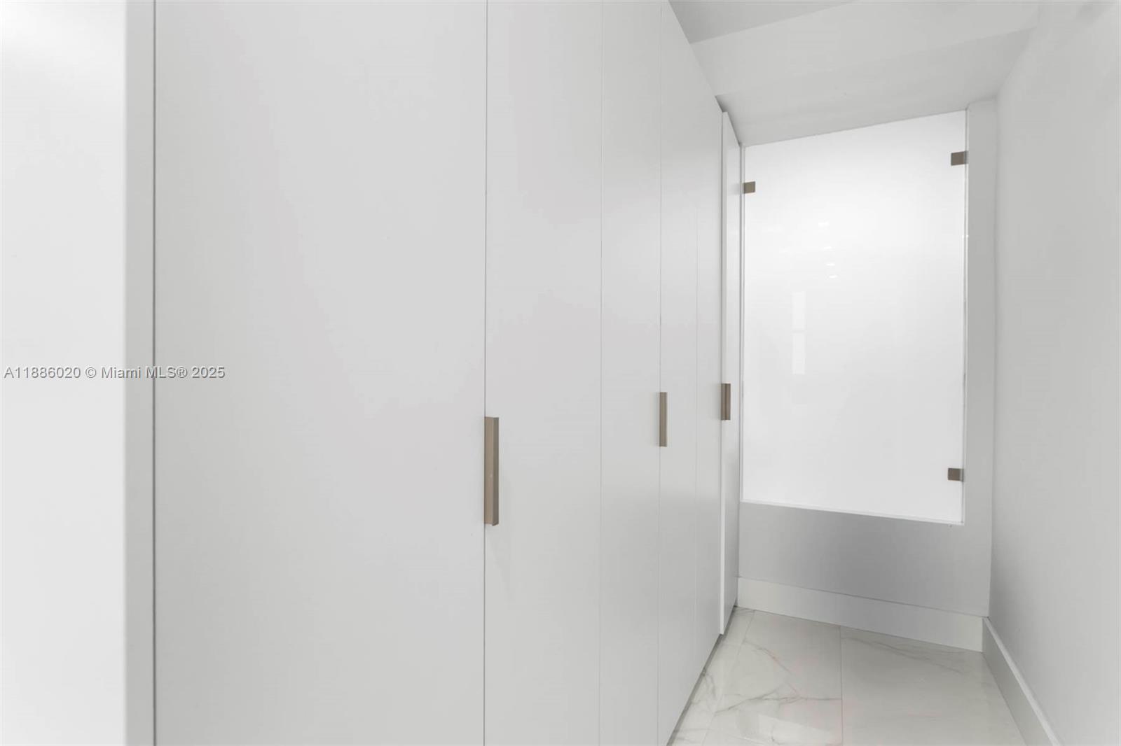 5001 Collins Avenue, Unit 8C Miami Beach, FL 33140 - Photo 8 of 27 a bathroom with a glass shower door