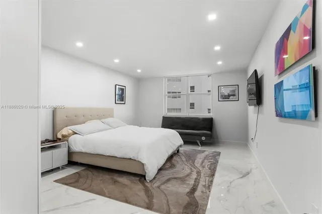 a bedroom with a bed and a tv