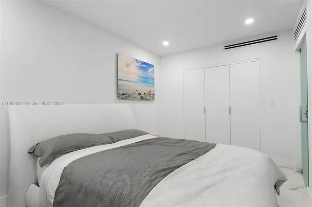 a bedroom with a bed and a painting