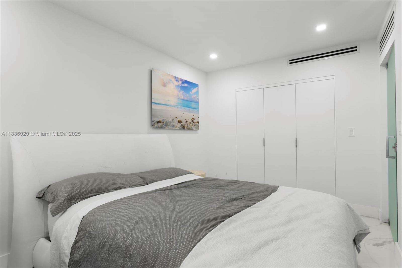 5001 Collins Avenue, Unit 8C Miami Beach, FL 33140 - Photo 10 of 27 a bedroom with a bed and a painting