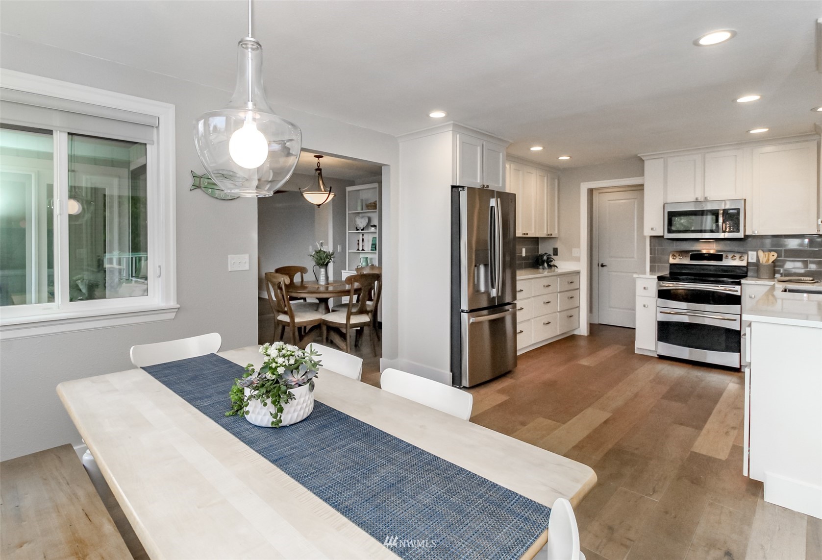 6102 Agnes Road Northeast Tacoma, WA 98422 - Photo 13 of 40 a kitchen with stainless steel appliances kitchen island granite countertop a refrigerator and a sink