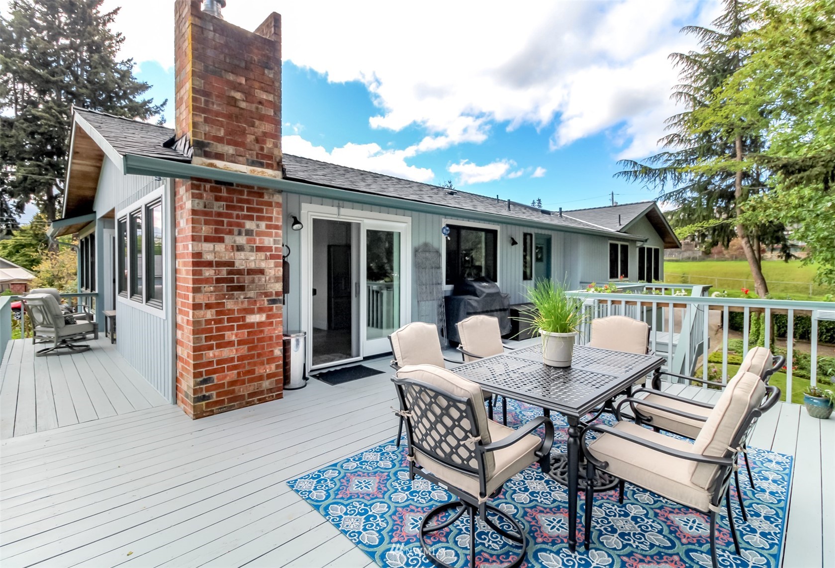 6102 Agnes Road Northeast Tacoma, WA 98422 - Photo 15 of 40 a view of a patio with table and chairs with wooden floor and fence