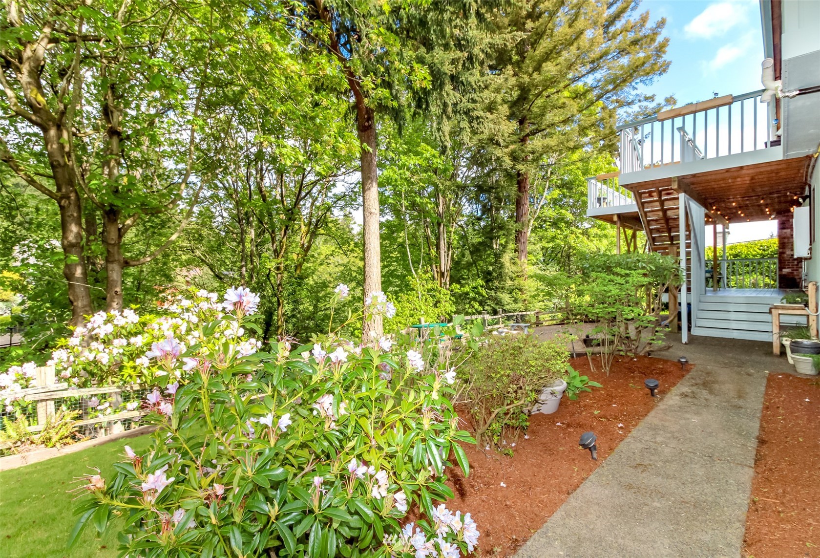 6102 Agnes Road Northeast Tacoma, WA 98422 - Photo 39 of 40 a backyard of a house with large trees and plants