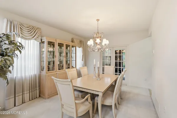 a view of a dining room with furniture and window