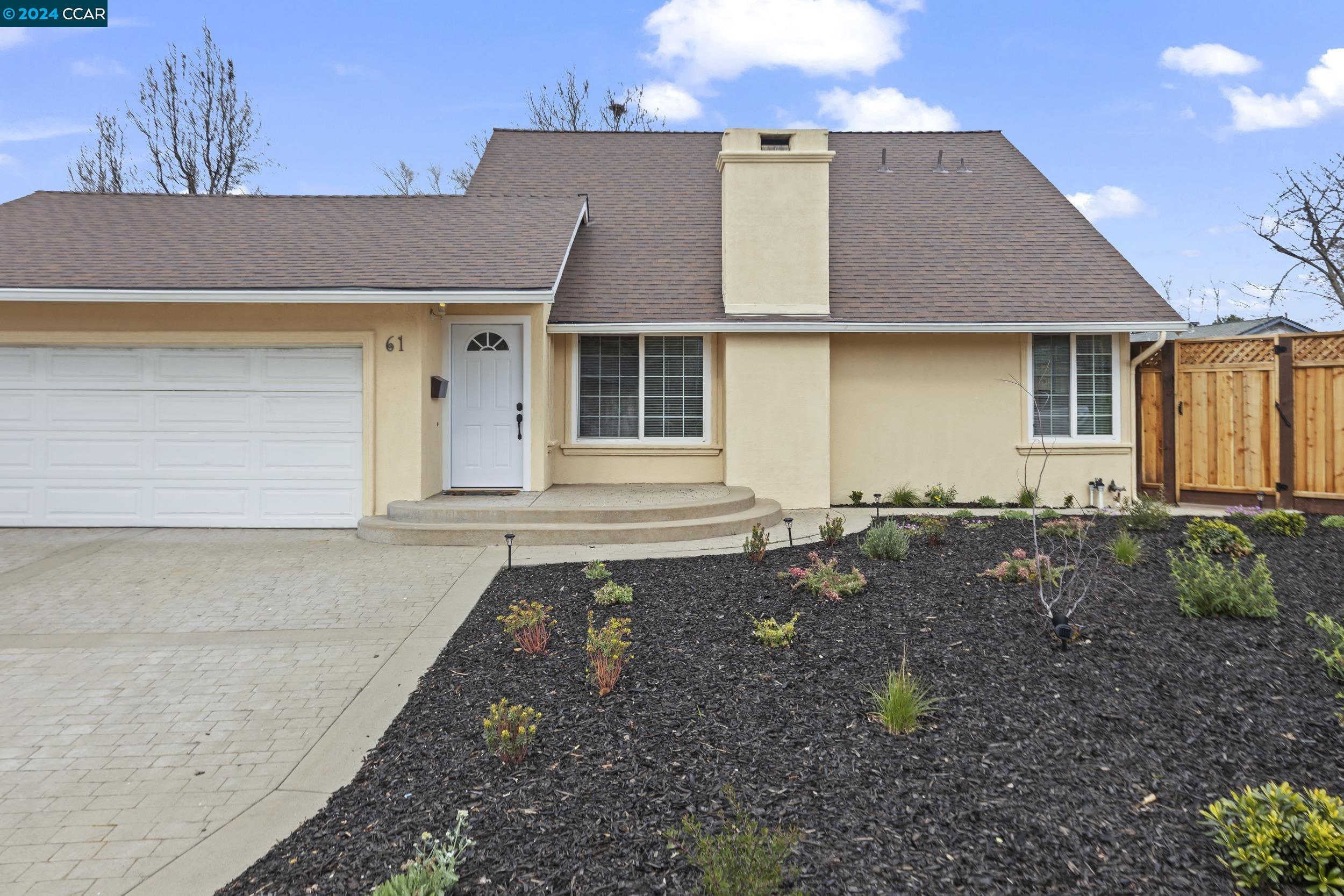 a front view of a house with garden