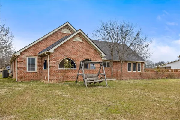 a front view of house with yard and green space