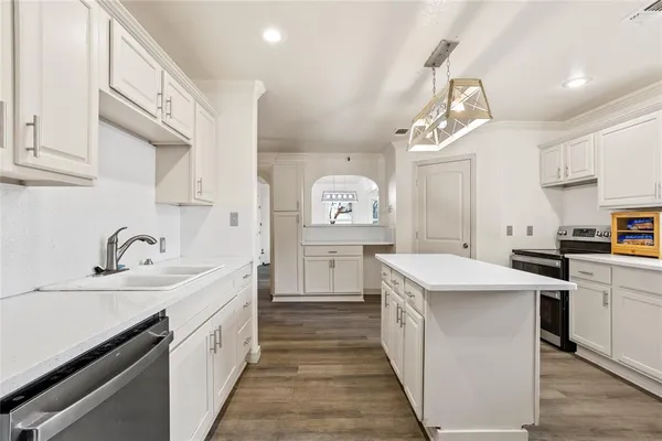 a kitchen with a sink stove and cabinets