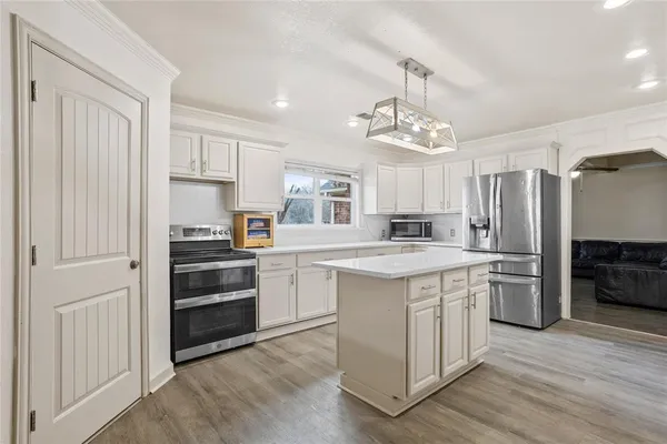 a kitchen with stainless steel appliances a refrigerator stove and sink