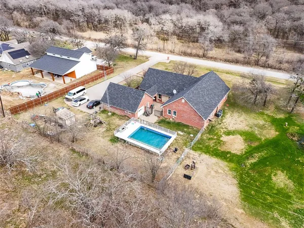 an aerial view of residential houses with outdoor space