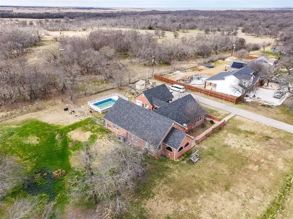 an aerial view of residential houses with outdoor space