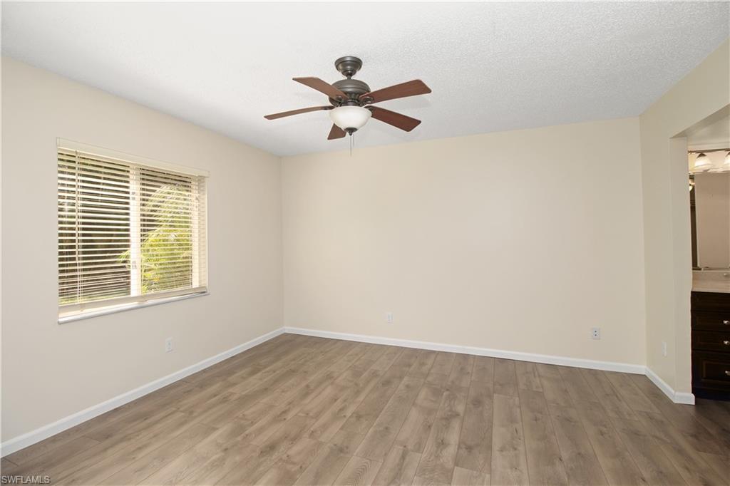 3471 County Barn Road, Unit F103 Naples, FL 34112 - Photo 12 of 27 a view of empty room with wooden floor and fan