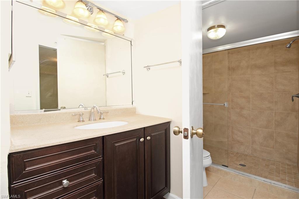 3471 County Barn Road, Unit F103 Naples, FL 34112 - Photo 13 of 27 a bathroom with a sink and a mirror