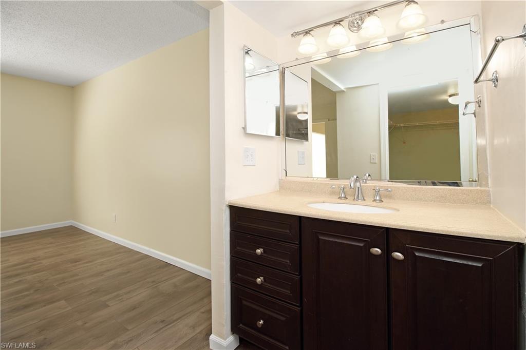 3471 County Barn Road, Unit F103 Naples, FL 34112 - Photo 15 of 27 a bathroom with a sink and a mirror