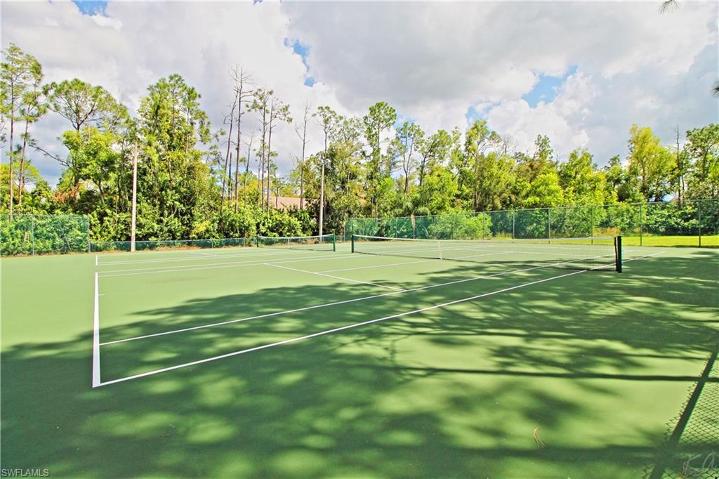 3471 County Barn Road, Unit F103 Naples, FL 34112 - Photo 26 of 27 a view of a field with trees in the background