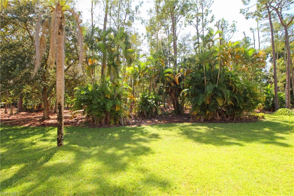 3471 County Barn Road, Unit F103 Naples, FL 34112 - Photo 5 of 27 a view of swimming pool with a yard and trees