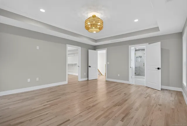 a kitchen with stainless steel appliances granite countertop a stove a sink dishwasher and a fireplace with wooden floor