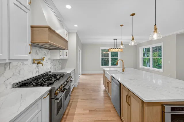 a kitchen with stainless steel appliances a sink stove and cabinets