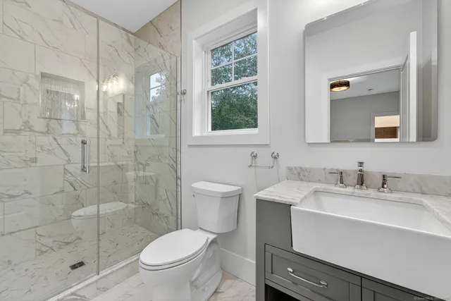 a bathroom with a toilet and a shower