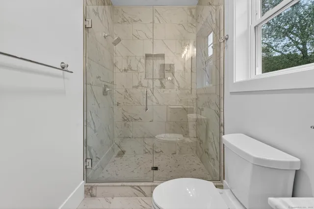 a kitchen with white cabinets and sink
