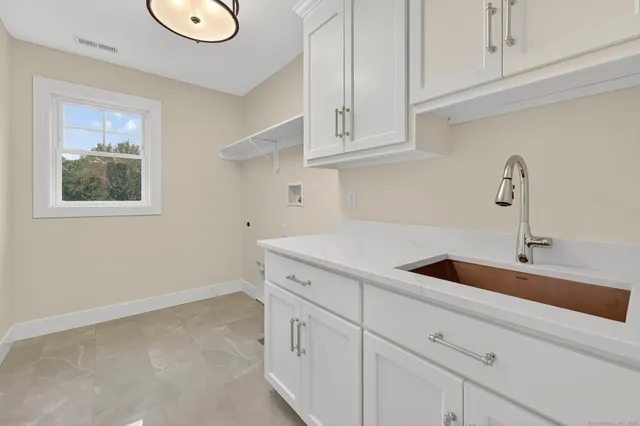 a bathroom with a granite countertop toilet sink and mirror