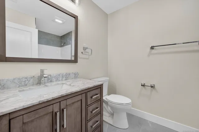 a bathroom with a granite countertop shower