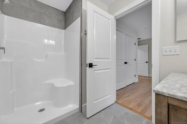 a bathroom with a toilet and a shower