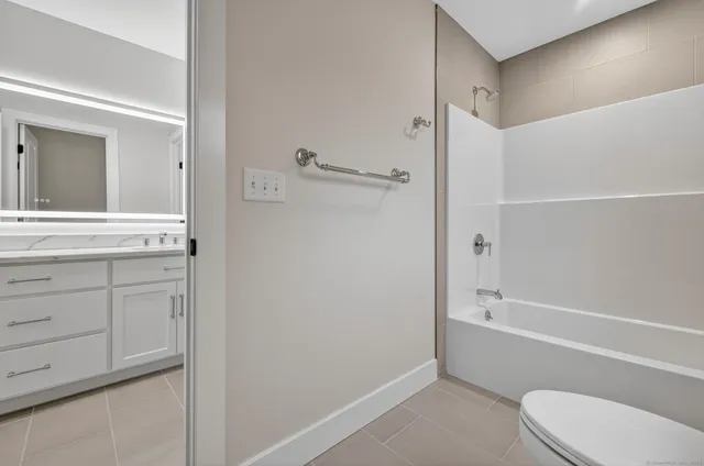 a view of a deck with couches table and chairs and potted plants