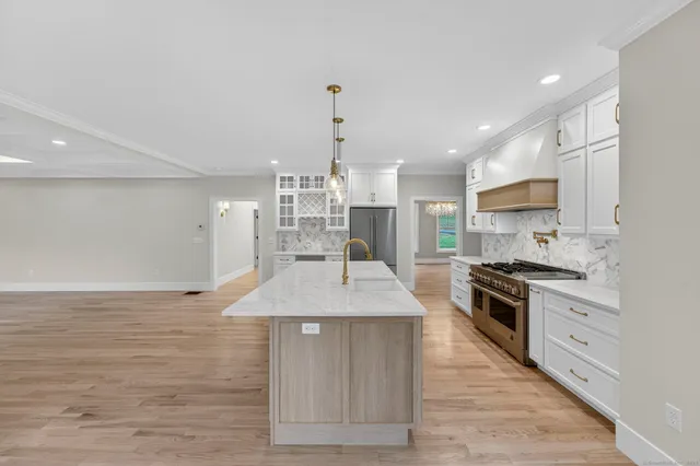 a stove top oven sitting inside of a kitchen