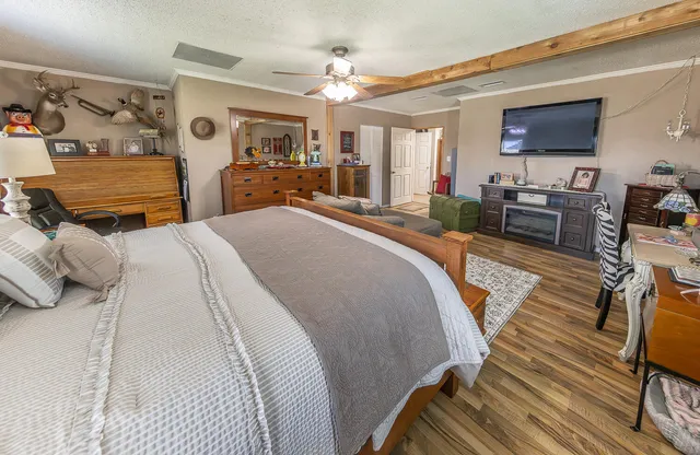 a spacious bedroom with a bed a couch and dresser