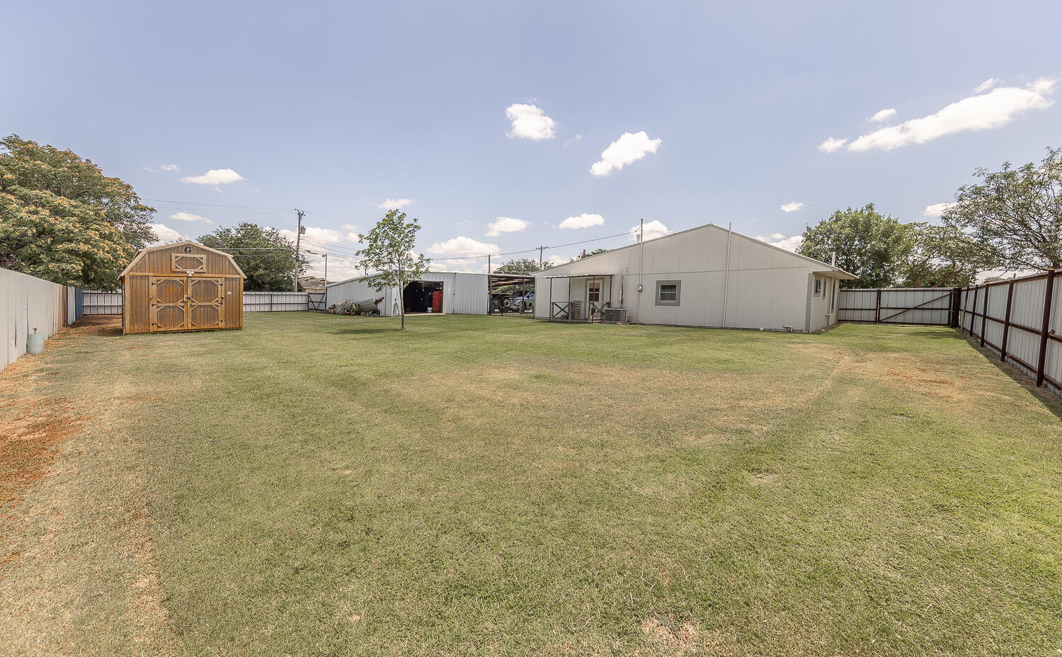 450 South 12th Street Slaton, TX 79364 - Photo 18 of 26 a view of a house with a yard and garage