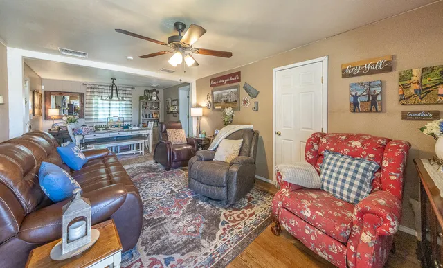 a living room with furniture and a chandelier