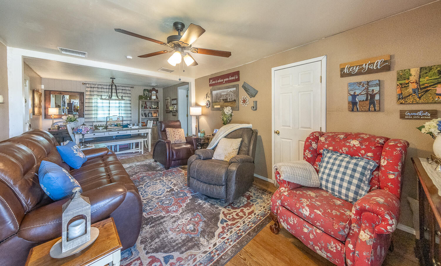 450 South 12th Street Slaton, TX 79364 - Photo 4 of 26 a living room with furniture and a chandelier