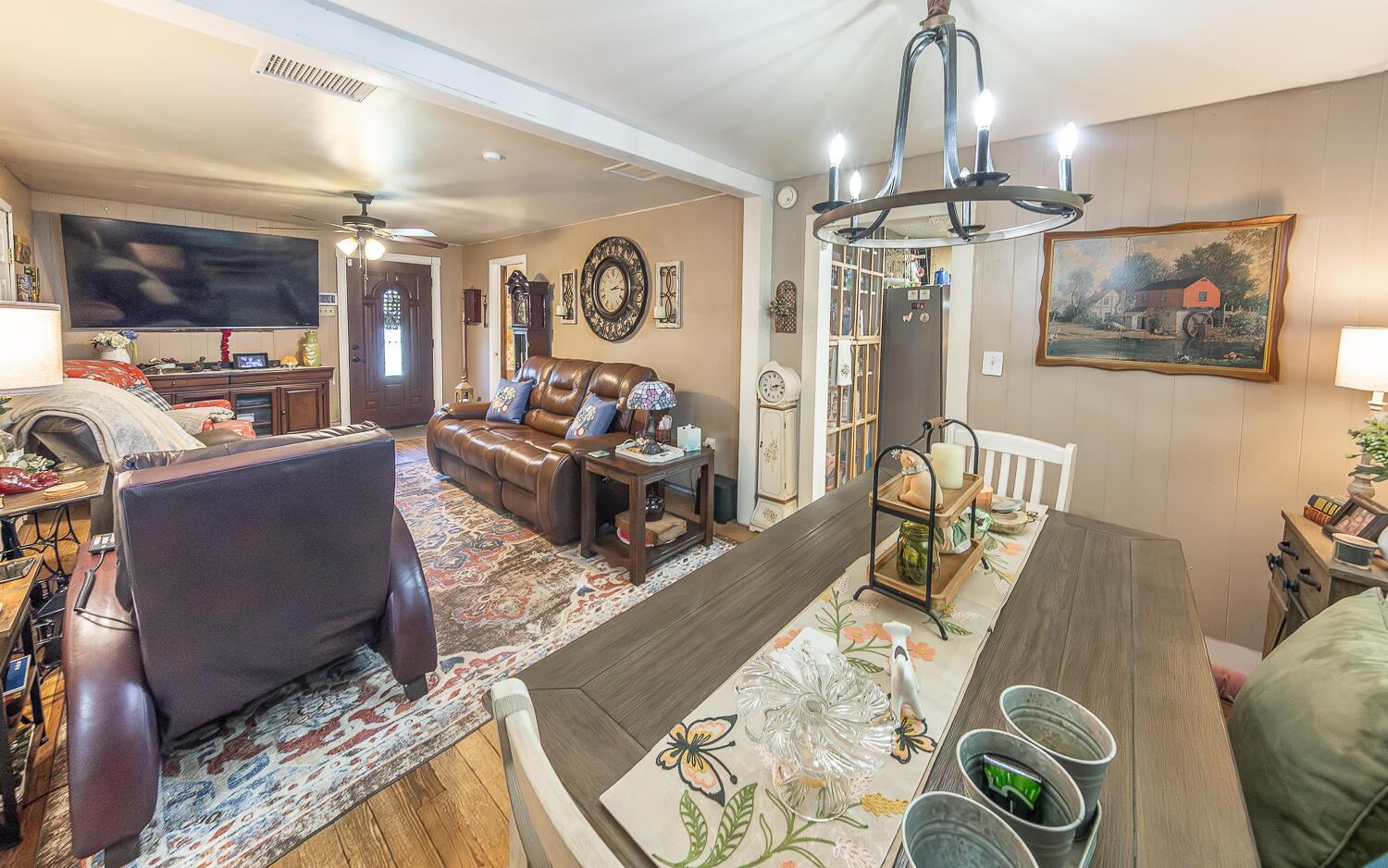 450 South 12th Street Slaton, TX 79364 - Photo 7 of 26 a living room with furniture and a chandelier